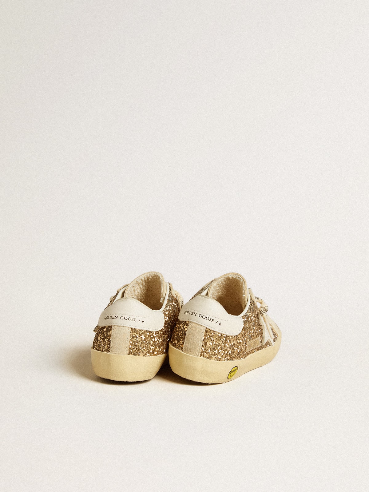 Super-Star Junior in gold glitter with white leather star and heel tab| Golden Goose